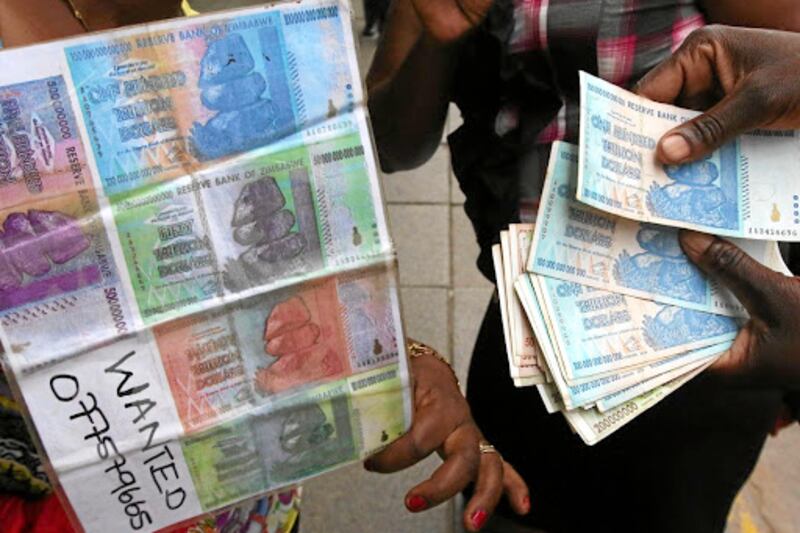 An illegal foreign currency trader counts notes at a local bus station in Zimbabwe’s capital Harare in November 2016. Picture: REUTERS
