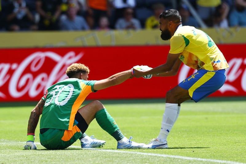 Mamelodi Sundowns' Keanu Cupido helps up Ronwen Williams after Borussia Dortmund's Felix Nmecha scores their first goal. Picture REUTERS/KAI PFAFFENBACH